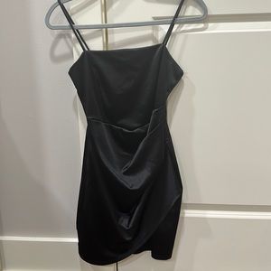 The dress is composed of a satin-like fabric that offers a moderate stretch.